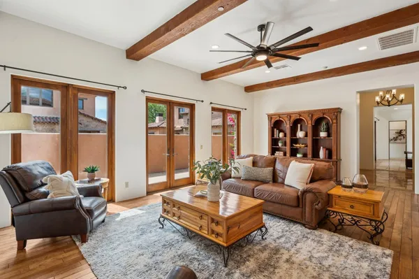 a living room with furniture a ceiling fan and a window