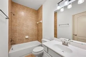 a bathroom with a bathtub shower sink vanity mirror and toilet