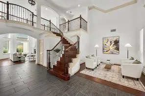 a living room with furniture and stairs