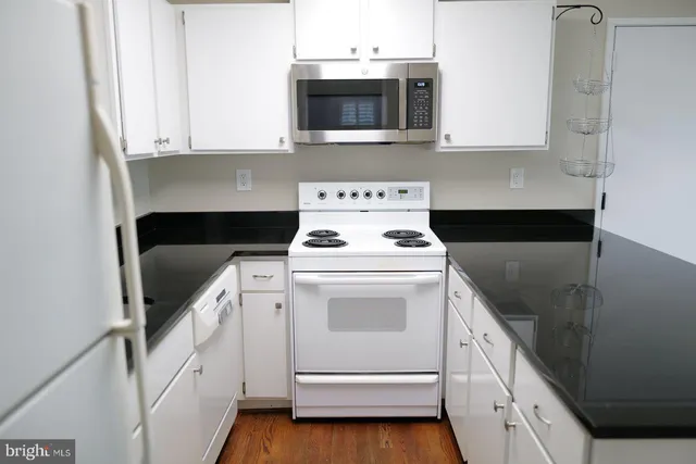 a kitchen with a stove and a microwave