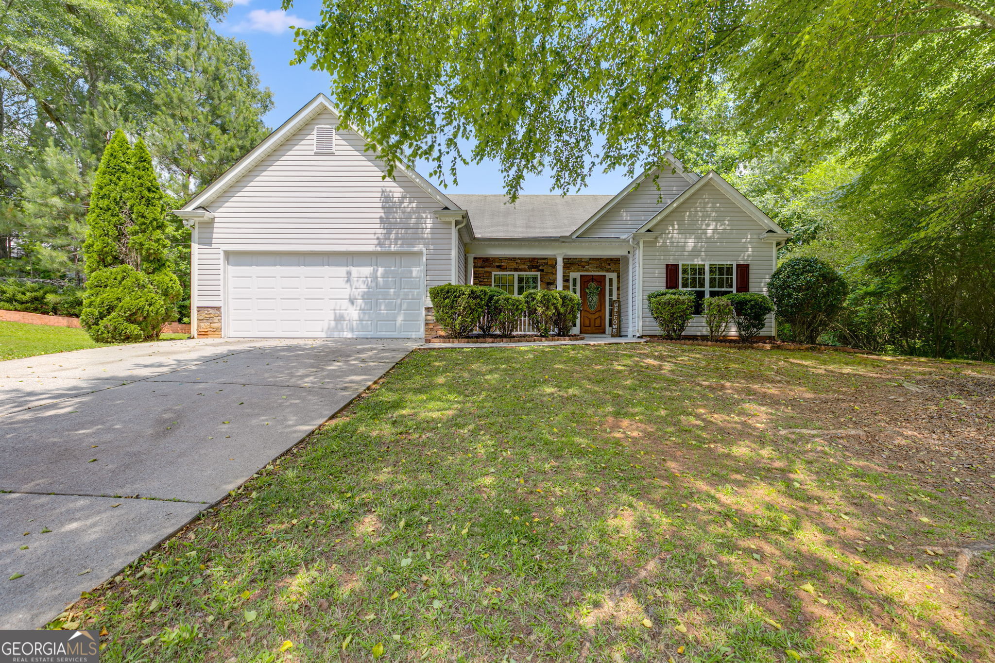 a front view of a house with a yard and garage