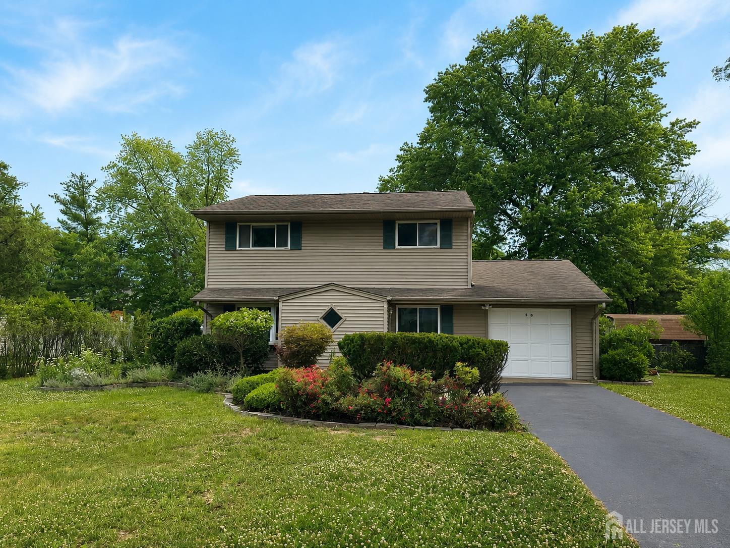 a front view of a house with a garden