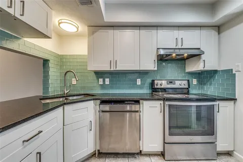a kitchen with stainless steel appliances granite countertop a sink and cabinets