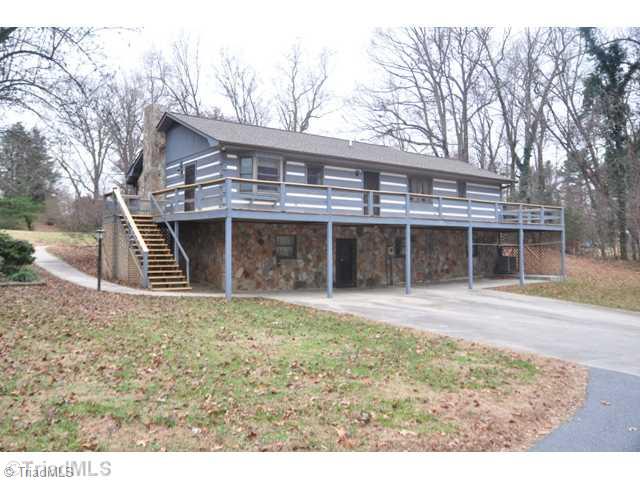6711 Bastille Lane Oak Ridge, NC 27310 - Photo 2 of 16 Exterior Front. Enjoy the rear deck for cookouts or evening shade over the patio. Beautiful Stonework inside and outside of home.