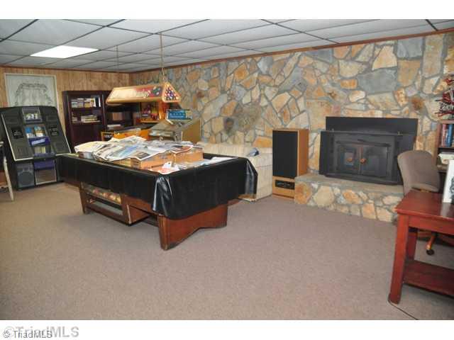 6711 Bastille Lane Oak Ridge, NC 27310 - Photo 13 of 16 Playroom. Just a few of the items which make this a true playroom - imagine your own jukebox, game machines, relaxing in front of the wood stove in your favorite chair and watching the ball games.