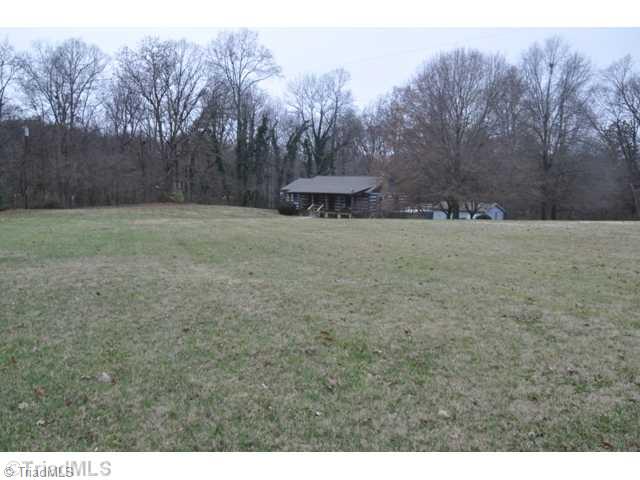 6711 Bastille Lane Oak Ridge, NC 27310 - Photo 3 of 16 Exterior Front. Privacy on this 2.51 acres.