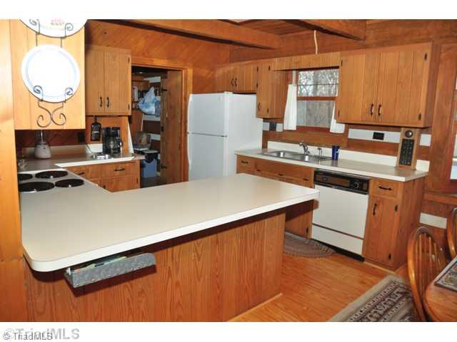 6711 Bastille Lane Oak Ridge, NC 27310 - Photo 7 of 16 Kitchen. Range - Microwave - Dishwasher -under counter drawer for a small hideaway.