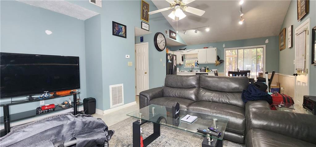 211 Brooks Lane Winder, GA 30680 - Photo 11 of 27 a living room with furniture and a flat screen tv