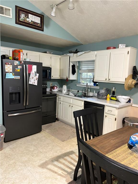 211 Brooks Lane Winder, GA 30680 - Photo 13 of 27 a kitchen with a table chairs microwave and cabinets