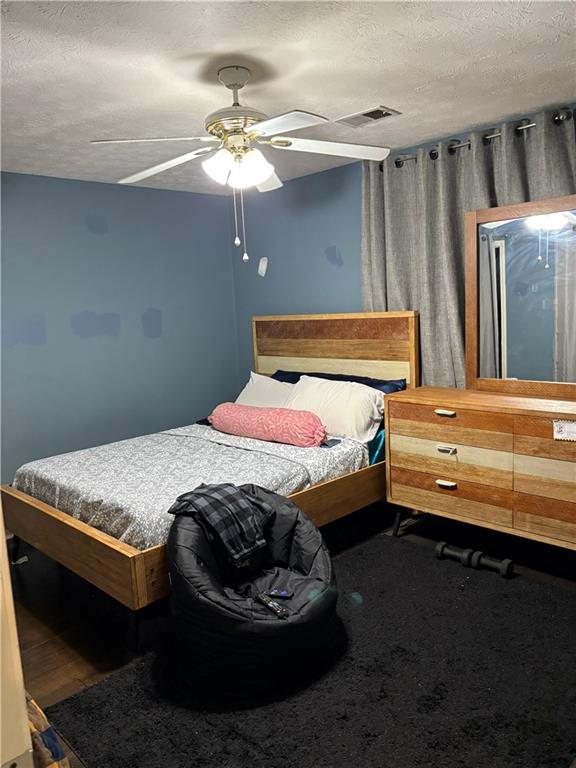 211 Brooks Lane Winder, GA 30680 - Photo 24 of 27 a bedroom with a bed and a chandelier