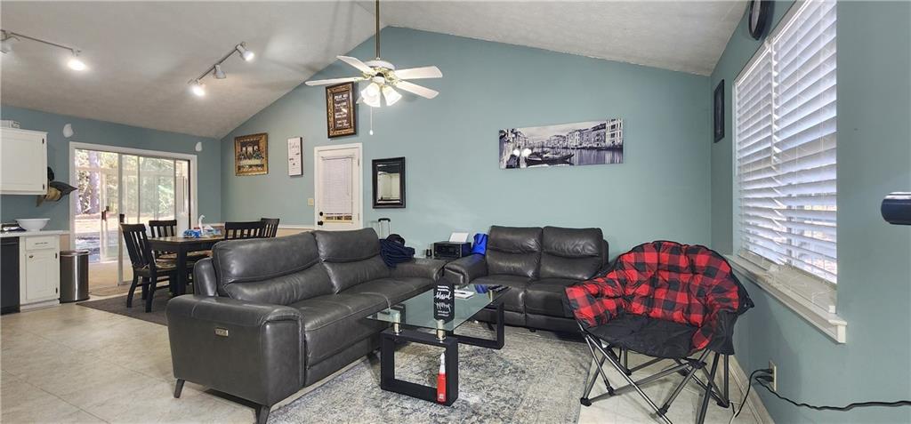 211 Brooks Lane Winder, GA 30680 - Photo 9 of 27 a living room with furniture and a chandelier