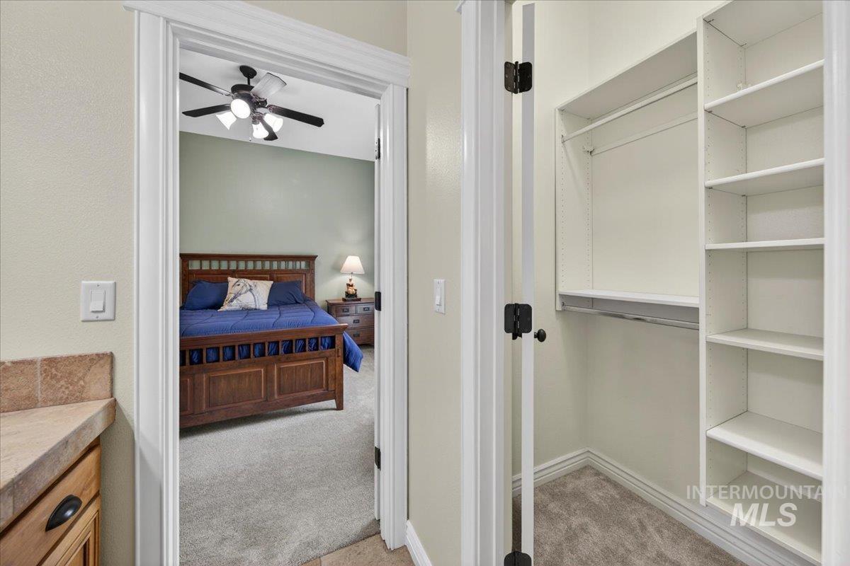 414 East Shafer View Drive Meridian, ID 83642 - Photo 30 of 50 Walk-in closet featuring built-in shelving and hanging rods adjoining Bedroom #4