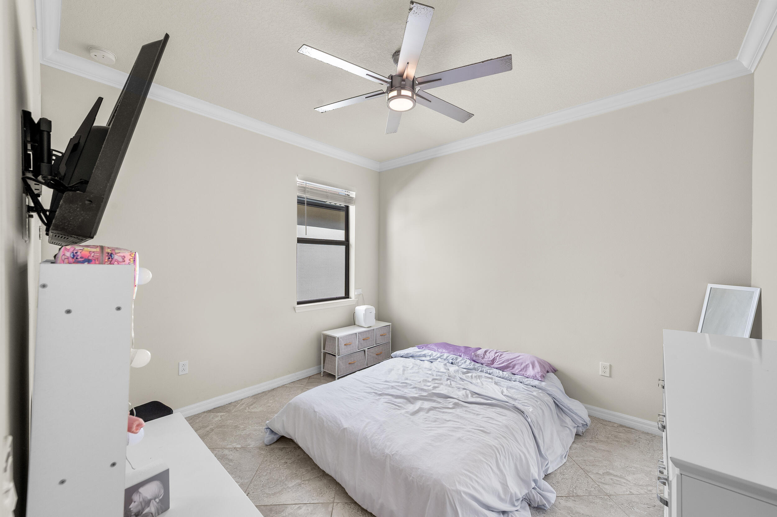 4762 Roldan Court Lake Worth, FL 33467 - Photo 16 of 33 a bedroom with a bed and a flat screen tv