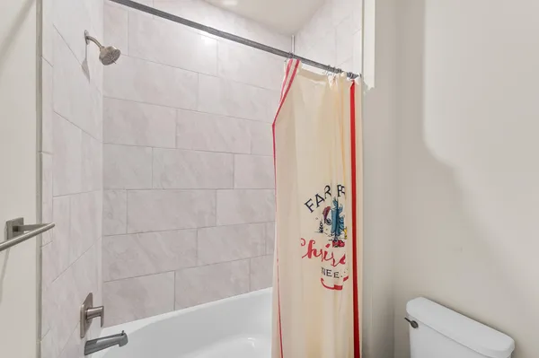 a bathroom with a shower and toilet