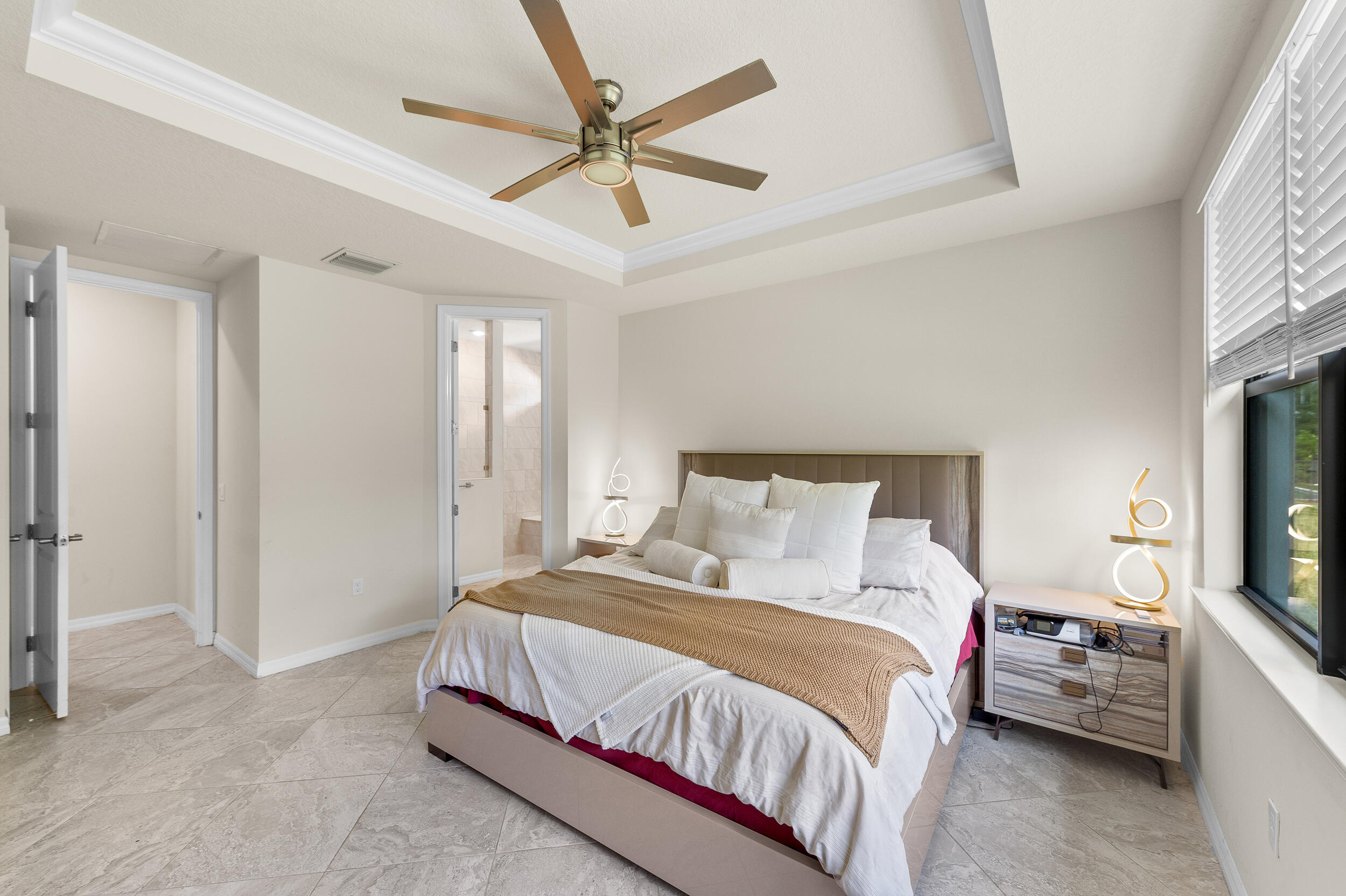 4762 Roldan Court Lake Worth, FL 33467 - Photo 22 of 33 a spacious bedroom with a bed and a flat screen tv