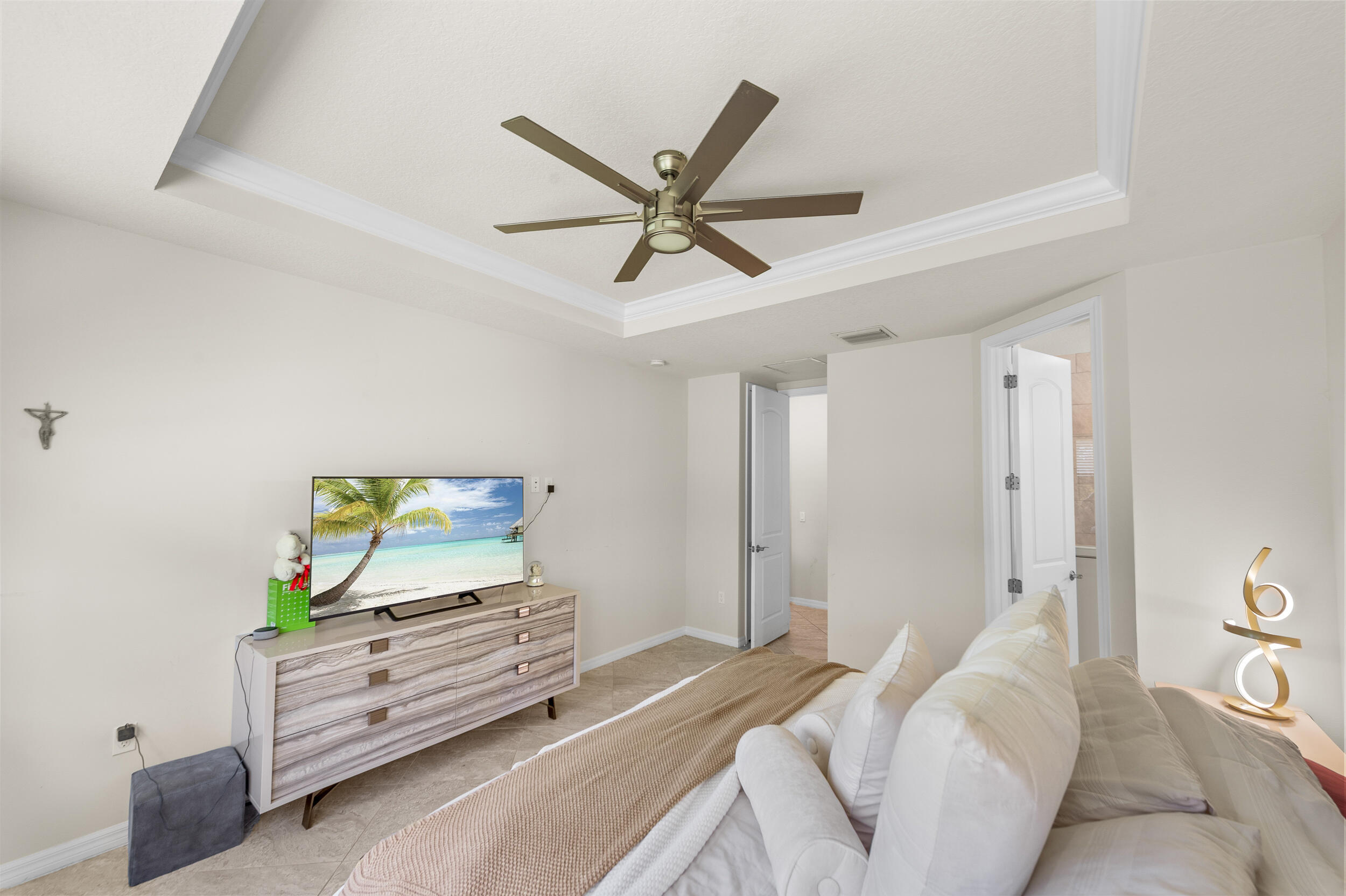 4762 Roldan Court Lake Worth, FL 33467 - Photo 23 of 33 a bedroom with a bed and a flat screen tv