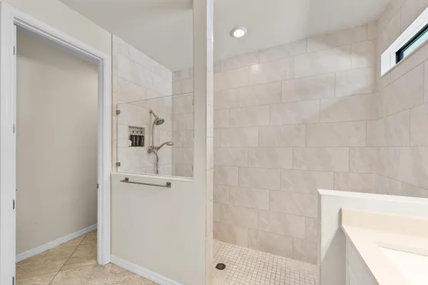 a bathroom with a shower and mirror