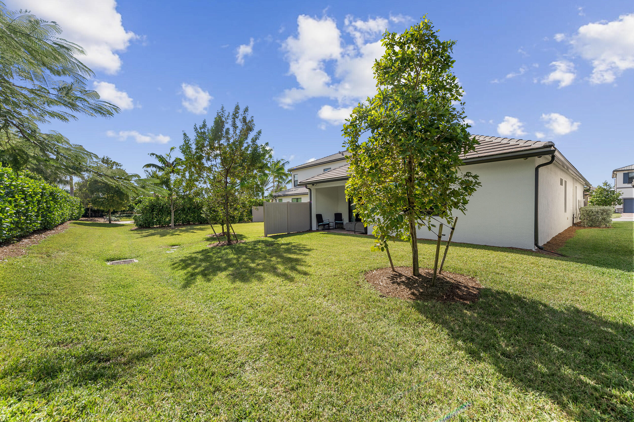 4762 Roldan Court Lake Worth, FL 33467 - Photo 28 of 33 a backyard of a house with lots of green space