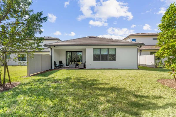 a view of a house with backyard and sitting area