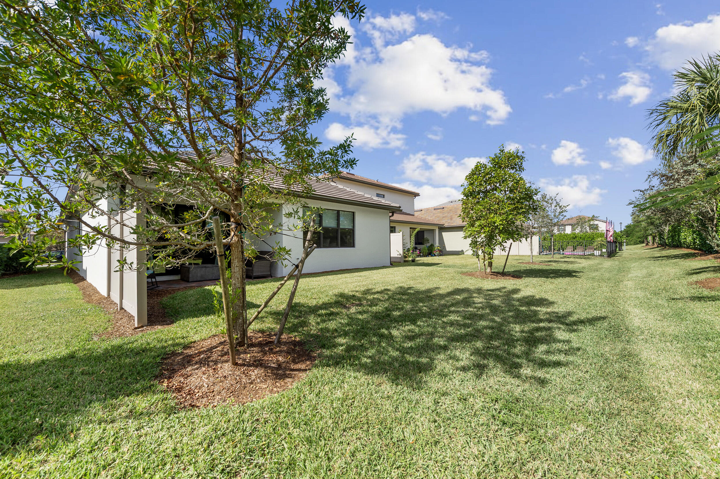 4762 Roldan Court Lake Worth, FL 33467 - Photo 30 of 33 a view of a house with backyard and a tree