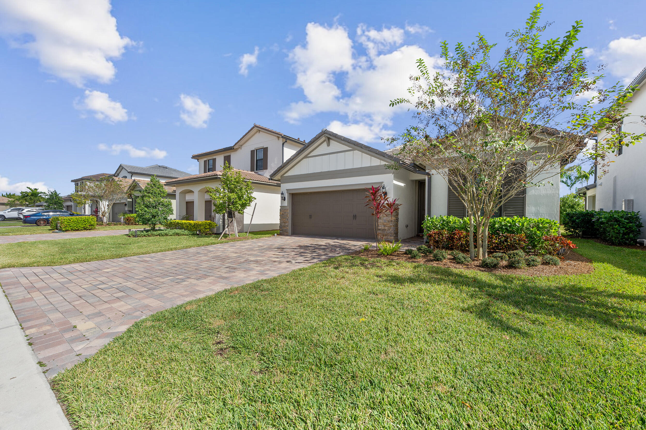 4762 Roldan Court Lake Worth, FL 33467 - Photo 3 of 33 a front view of a house with a yard and garage