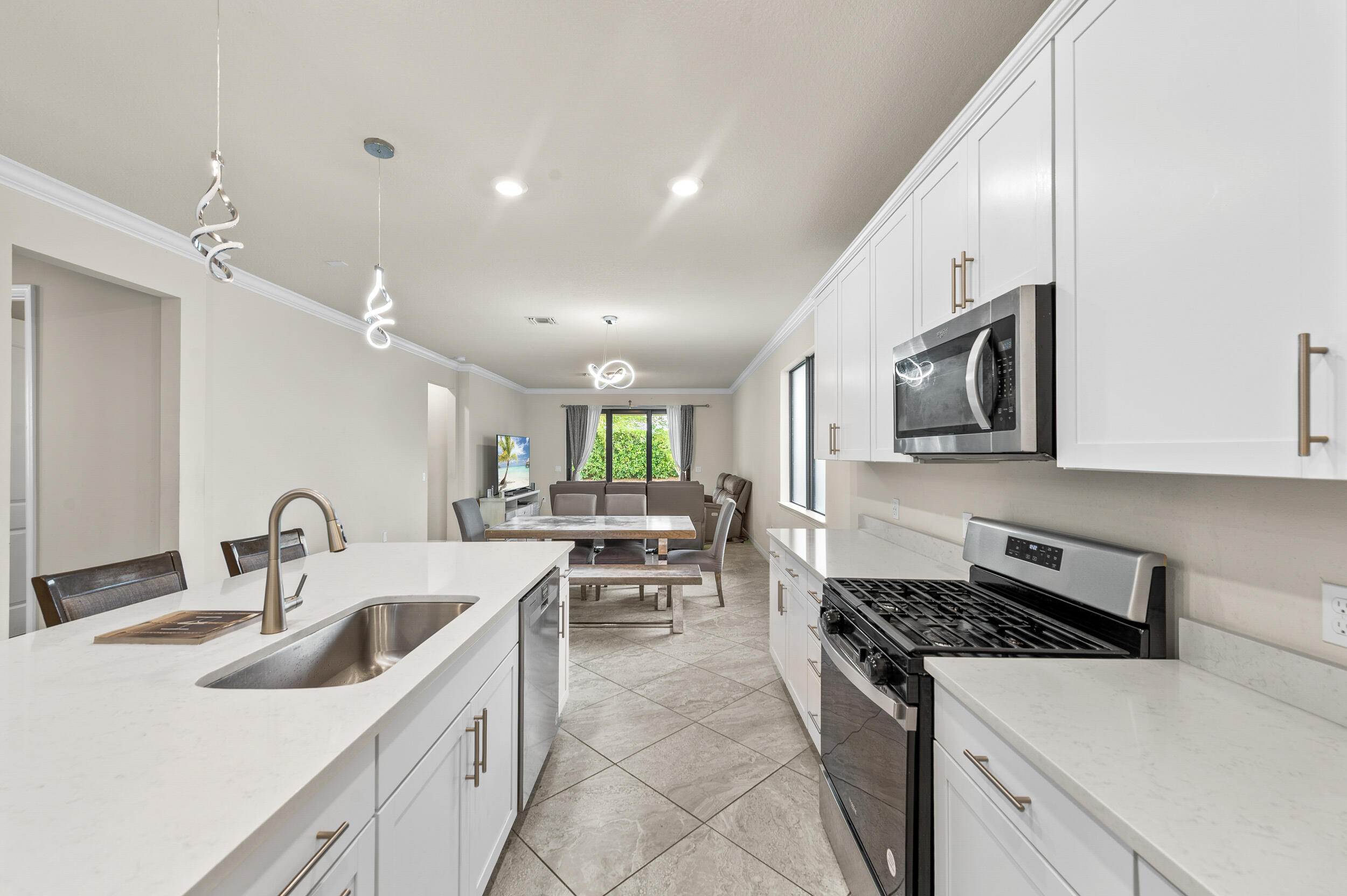 4762 Roldan Court Lake Worth, FL 33467 - Photo 7 of 33 a kitchen with stainless steel appliances a sink a stove and cabinets