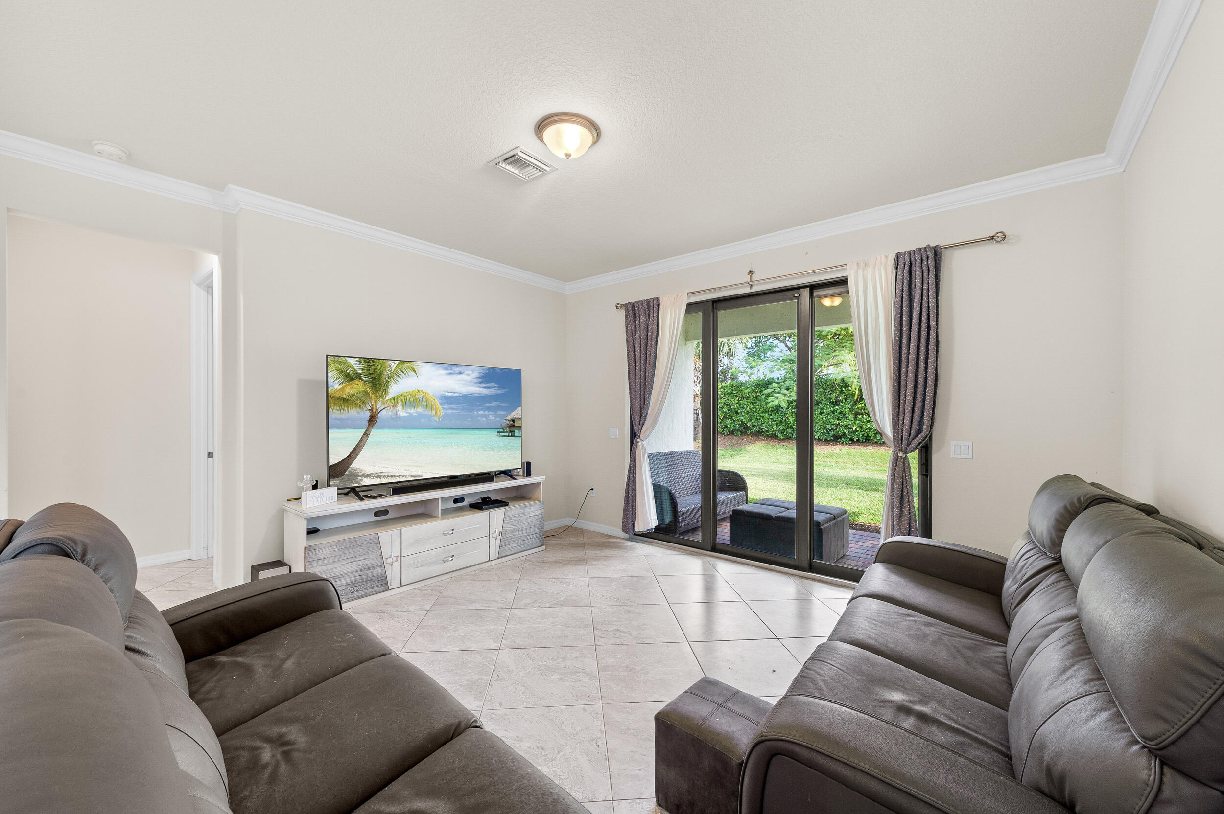 4762 Roldan Court Lake Worth, FL 33467 - Photo 10 of 33 a living room with furniture and a flat screen tv