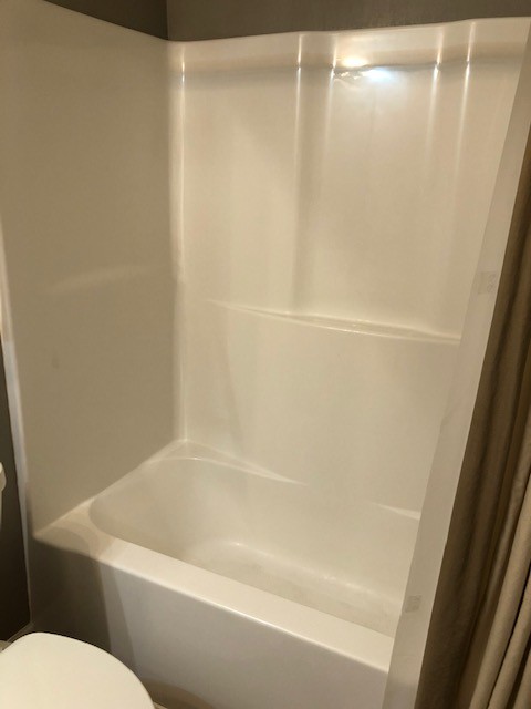5975 Campbell Road Cross Plains, TN 37049 - Photo 19 of 26 a white bath tub and a shower curtain