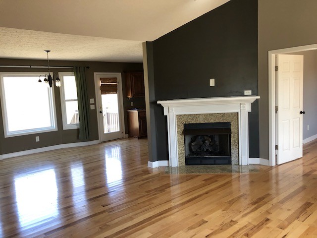 5975 Campbell Road Cross Plains, TN 37049 - Photo 4 of 26 a living room with a fireplace and wooden floor