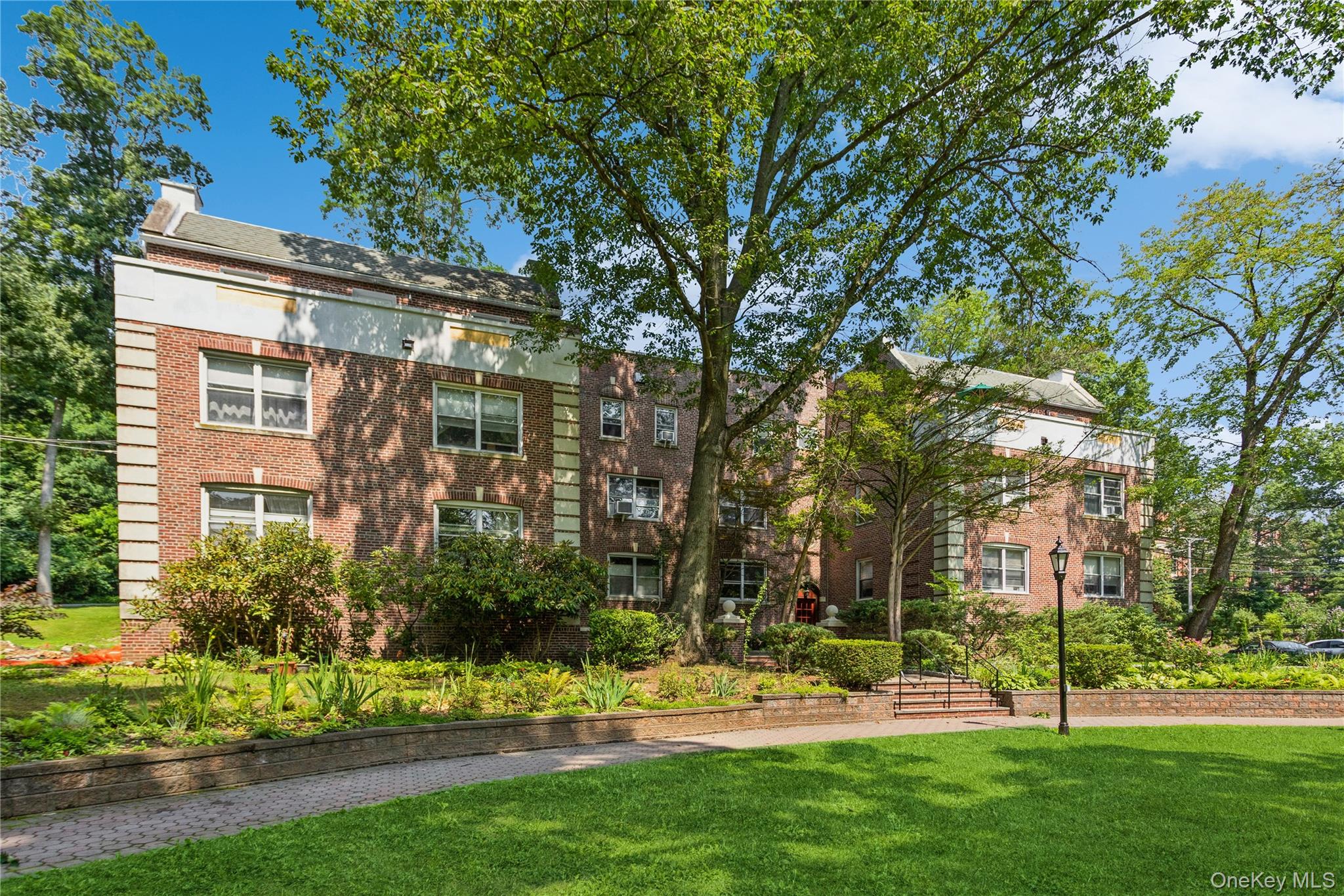 13 Sunnybrook Road, Unit 3D Bronxville, NY 10708 - Photo 17 of 17 a view of a building with a yard
