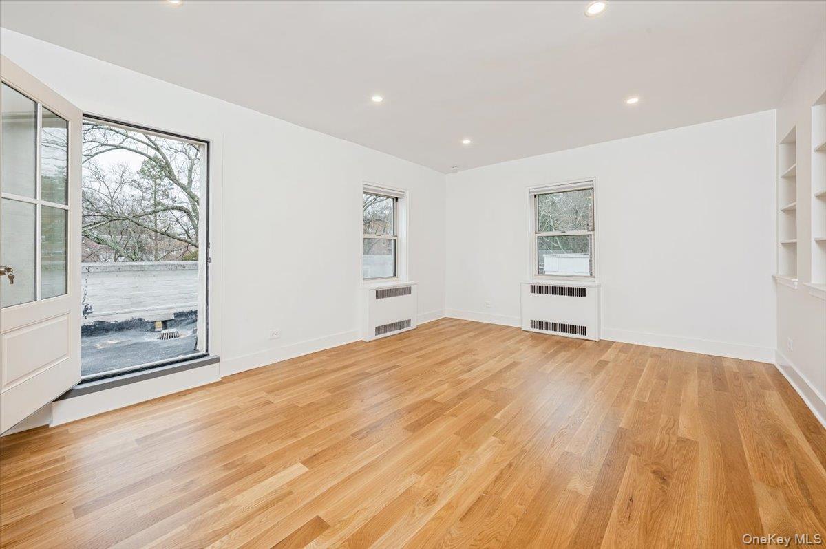 13 Sunnybrook Road, Unit 3D Bronxville, NY 10708 - Photo 3 of 17 a view of empty room with wooden floor and fan