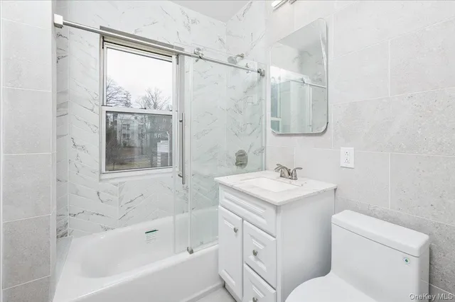 a bathroom with a sink toilet vanity and shower