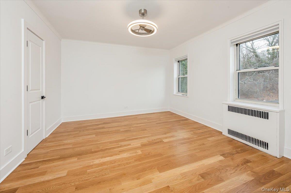 13 Sunnybrook Road, Unit 3D Bronxville, NY 10708 - Photo 10 of 17 a view of empty room with wooden floor and fan