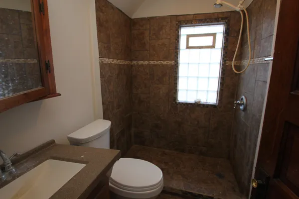 a white toilet sitting next to a bathroom sink