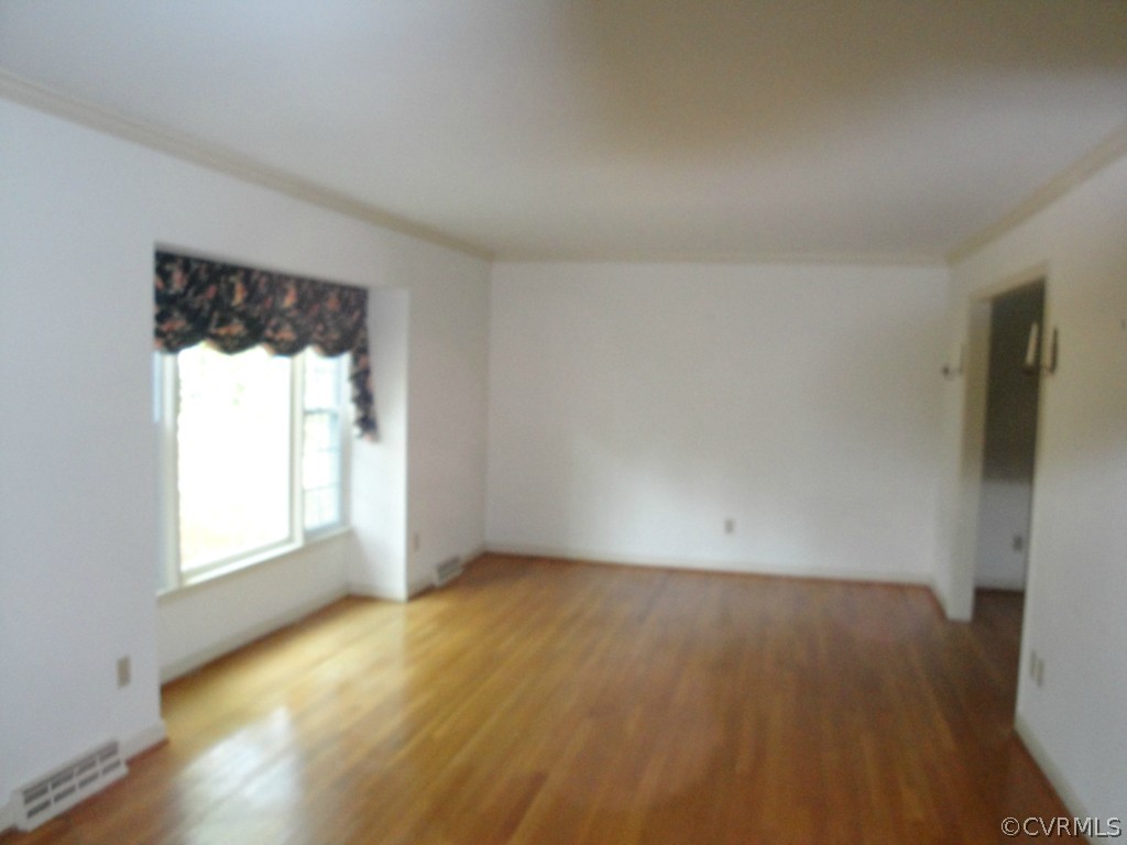 2655 Salisbury Road Midlothian, VA 23113 - Photo 3 of 7 an empty room with wooden floor and windows