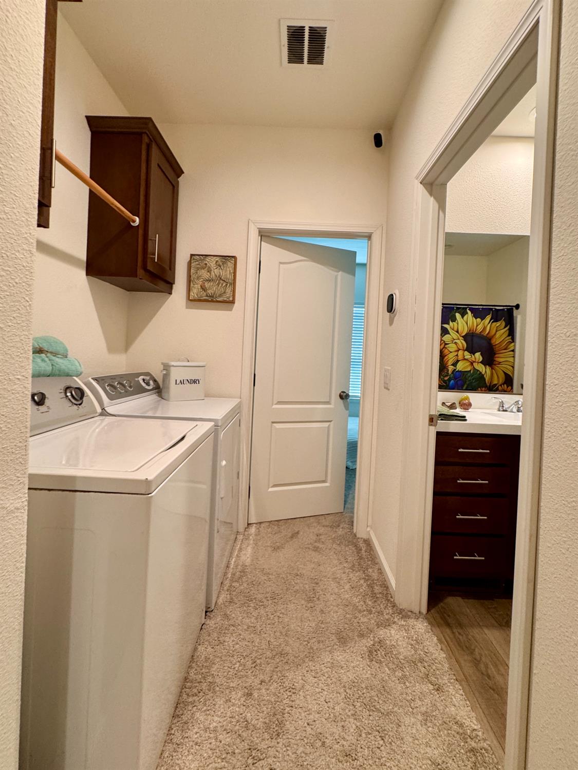 360 East Grant Line Road, Unit 16 Tracy, CA 95376 - Photo 15 of 36 Dedicated laundry area with a built-in wood-finish cabinet and hanging rod