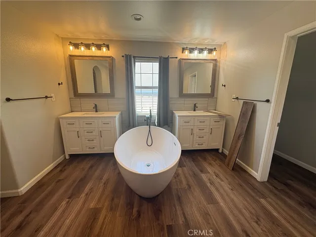 a view of a bathroom with dual sinks