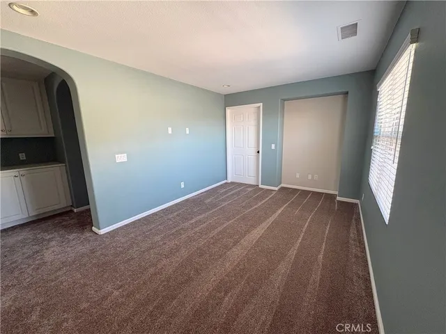 a view of a room with wooden floor and natural light