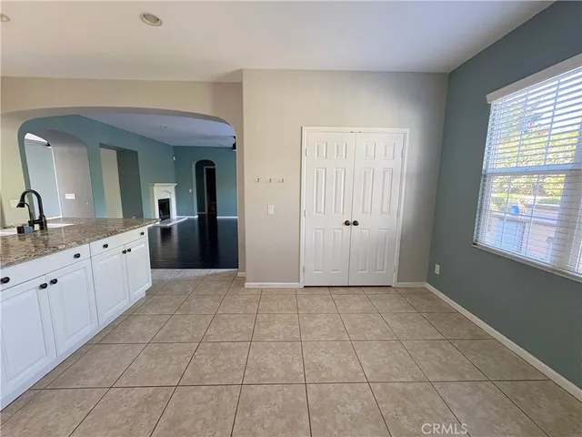a view of a kitchen with cabinet and mirrors