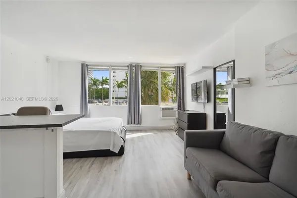 a bedroom with furniture and a window