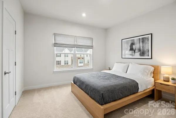 a bedroom with a large bed and a window