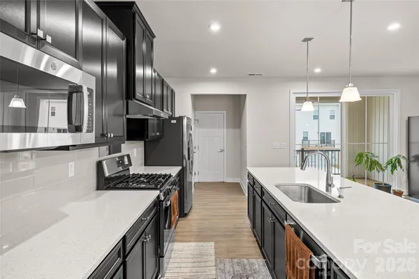 a kitchen with counter top space cabinets and stainless steel appliances