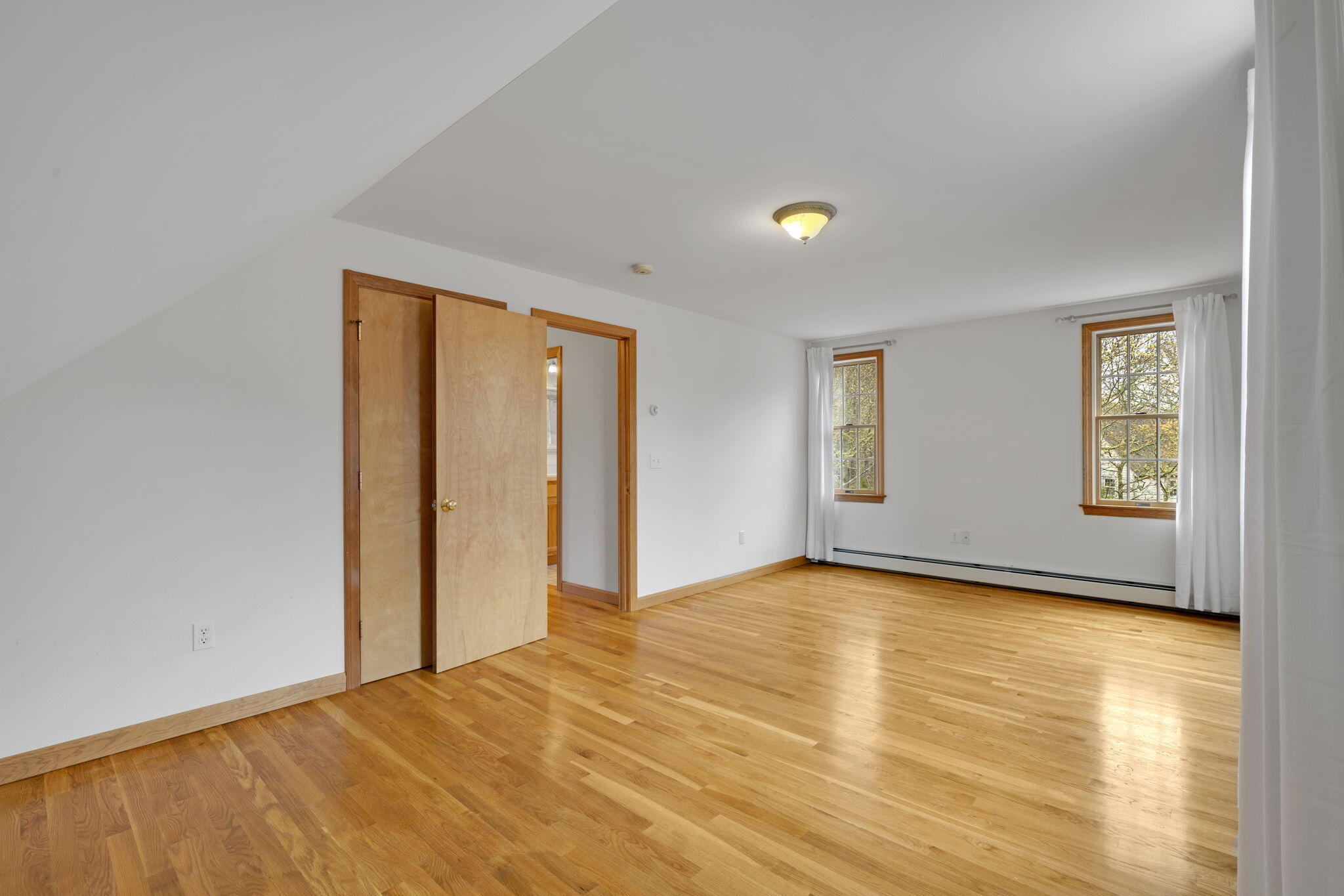 65 Whitney Road Eastham, MA 02642 - Photo 31 of 41 a view of an empty room with window and wooden floor