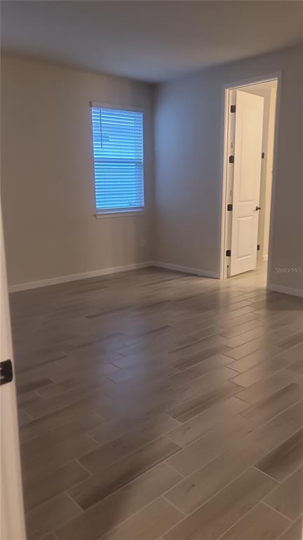 6558 Rover Way St. Cloud, FL 34771 - Photo 13 of 24 an empty room with wooden floor and windows