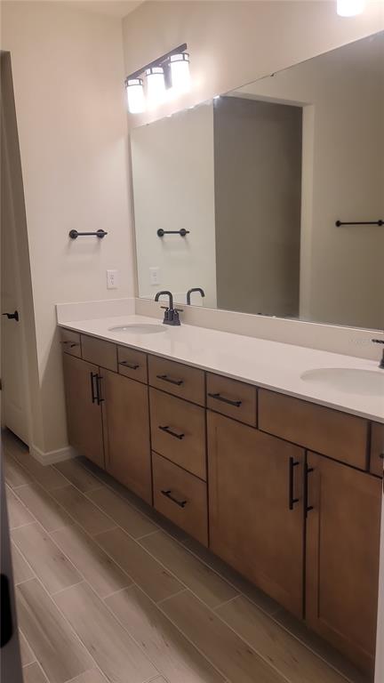 6558 Rover Way St. Cloud, FL 34771 - Photo 15 of 24 a spacious bathroom with a double vanity sink and mirror