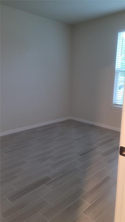 6558 Rover Way St. Cloud, FL 34771 - Photo 19 of 24 an empty room with wooden floor and windows