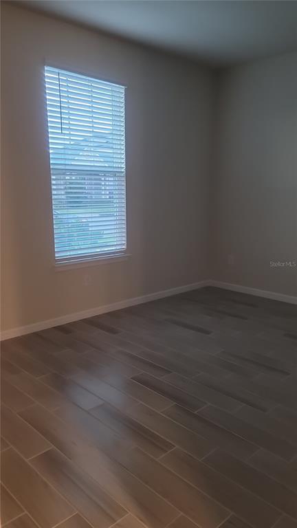 6558 Rover Way St. Cloud, FL 34771 - Photo 20 of 24 an empty room with wooden floor and windows