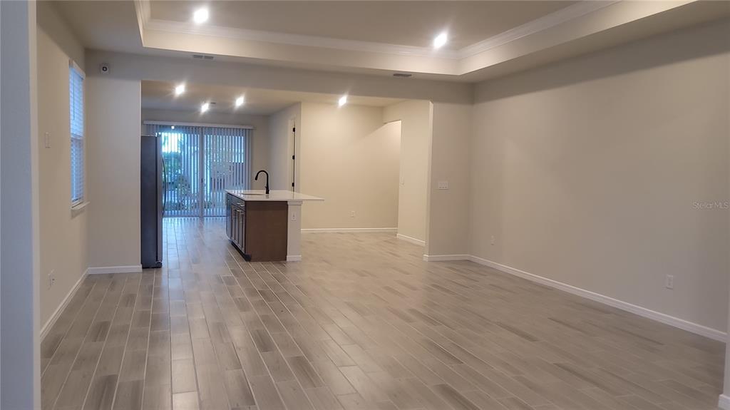6558 Rover Way St. Cloud, FL 34771 - Photo 6 of 24 a view of a big room with wooden floor and seating space