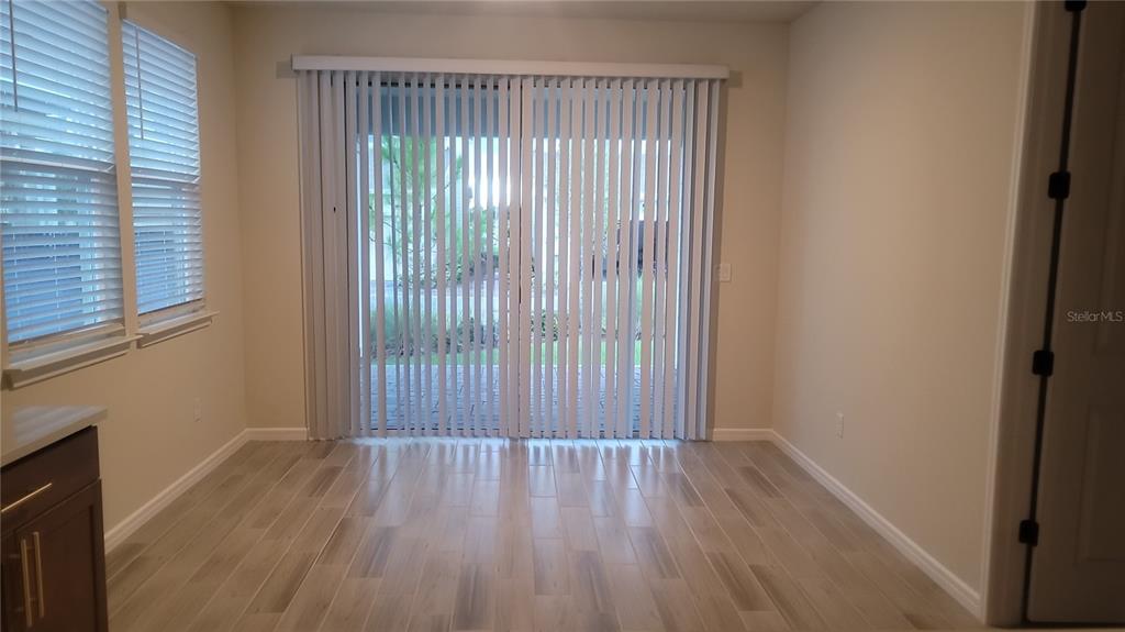 6558 Rover Way St. Cloud, FL 34771 - Photo 9 of 24 a view of a room with wooden floor and a window
