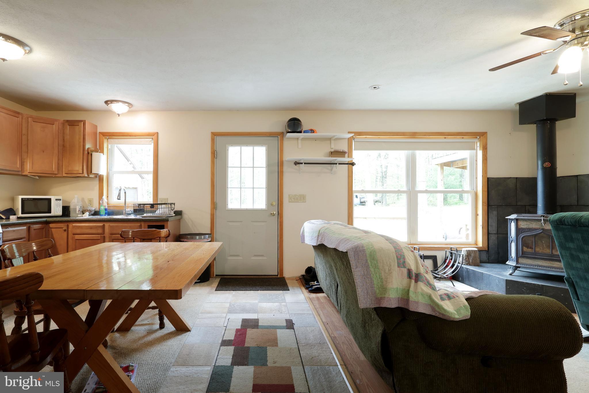 358 Buckridge Road Howard, PA 16841 - Photo 6 of 40 a living room with furniture and floor to ceiling windows